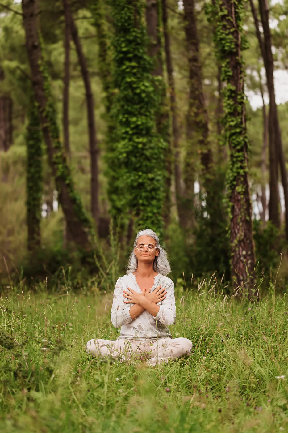 Meditating woman in the forest